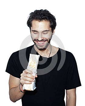 Young handsome Arab man eats with pleasure Donner kebab Shawarma. Isolation on a white background