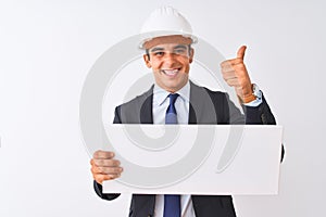 Young handsome architect man wearing helmet holding banner over isolated white background happy with big smile doing ok sign,