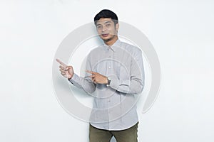 Young handsome asian business man pointing finger on empty space isolated on white background