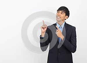 Young handsome asian business man pointing to the side with hand to present product