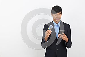 Young handsome asian business man using smartphone for online payment