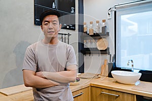 Young handsome asian man prepare salad food and cooking in the kitchen.