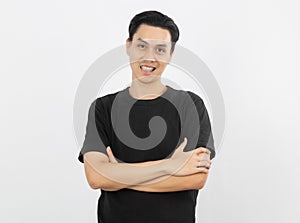 Young handsome asian man smiling with braces and looking at camera with arms crossed isolated on white background.