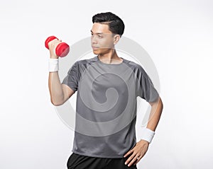 Young handsome asian man in sport outfits exercising with dumbbell isolated on white background. photo