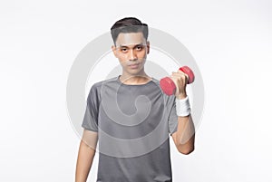 Young handsome asian man in sport outfits exercising with dumbbell and looking to camera isolated on white background. photo