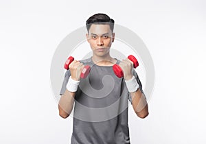 Young handsome asian man in sport outfits exercising with dumbbells and looking to camera isolated on white background. photo