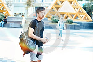 Young handsome asian men wearing casual black tshirt and backpack at day in Sai Gon city, Vietnam