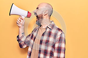 Young handsome bald man with angry expression