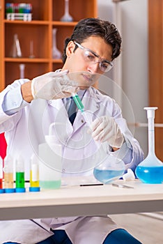 The young handsome biochemist working in the lab