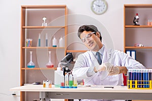 The young handsome biochemist working in the lab