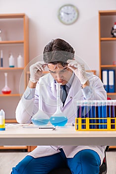 The young handsome biochemist working in the lab