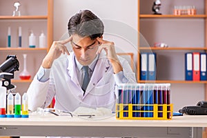 The young handsome biochemist working in the lab