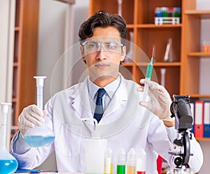 Young handsome biochemist working in the lab