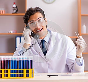 Young handsome biochemist working in the lab