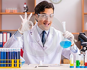 Young handsome biochemist working in the lab