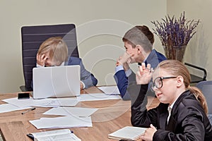 Young handsome blond boy, sitting at the table and shocked by the proposed ideas