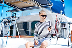 Young and handsome blond man talking on a mobile phone