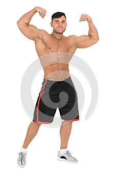 Young handsome bodybuilder man posing for fitness fashion shoot. Isolated on white.