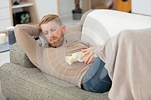 young handsome boy sleeping on sofa