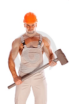 Young and handsome builder with a sledgehammer and