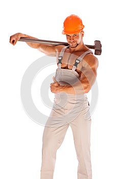 Young and handsome builder with a sledgehammer and