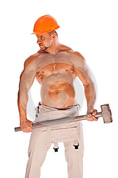 Young and handsome builder with a sledgehammer and