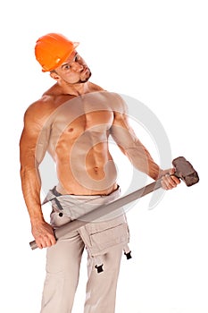 Young and handsome builder with a sledgehammer and