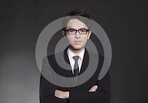Young handsome buisness man in black suit and wearing eyeglasses