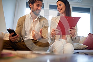 Young handsome business colleagues having a nice talk at a meeting in an apartment. Business, meeting, people