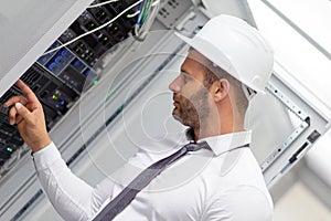 Young handsome business man engeneer in datacenter server room