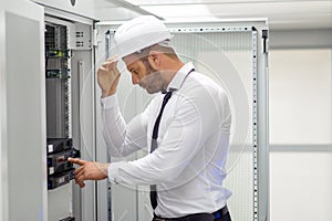 Young handsome business man engeneer in datacenter server room