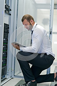 Young handsome business man engeneer in datacenter server room