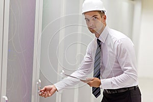 Young handsome business man engeneer in datacenter server room