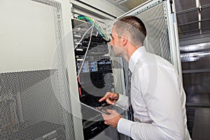 Young handsome business man engeneer in datacenter server room