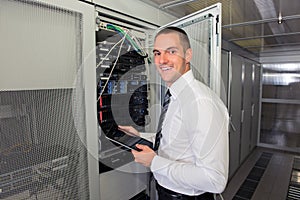 Young handsome business man engeneer in datacenter server room