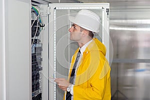 Young handsome business man engeneer in datacenter server room