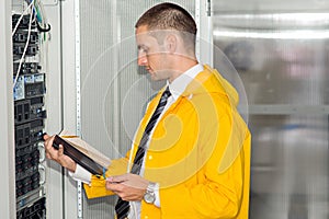 Young handsome business man engeneer in datacenter server room