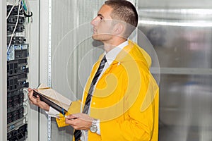 Young handsome business man engeneer in datacenter server room photo