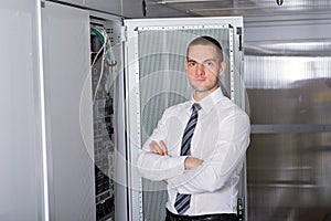 Young handsome business man engeneer in datacenter server room photo