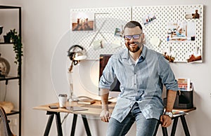 Young handsome business man freelancer working at home on computer photo