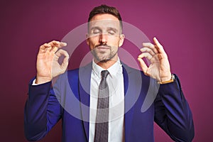 Young handsome business man over purple  background relax and smiling with eyes closed doing meditation gesture with