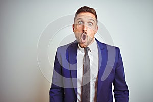 Young handsome business man over white isolated background afraid and shocked with surprise expression, fear and excited face