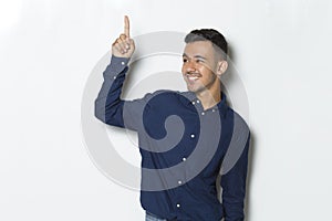 Young handsome business man pointing finger on empty space isolated on white background