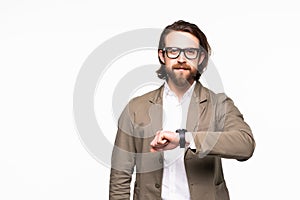 Young handsome business man running late and checking the time on his wrist watch isolated