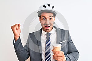 Young handsome business man wearing bike helmet and take away coffee over isolated background screaming proud and celebrating