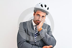 Young handsome business man wearing suit and tie and bike helmet over isolated background thinking looking tired and bored with