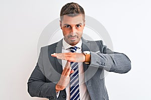 Young handsome business man wearing suit and tie over isolated background Doing time out gesture with hands, frustrated and