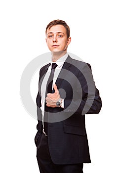 Young handsome businessman in black suit is standing straight, portrait isolated on white background