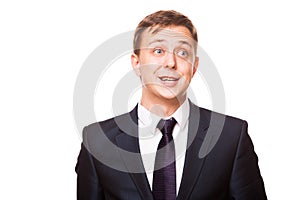 Young handsome businessman in black suit is standing straight, portrait isolated on white background