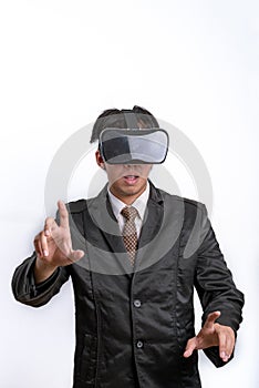 Young handsome businessman in black suit wearing virtual reality